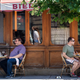 People eat outside during the lunch hour at a restaurant on 14th Street NW in Washington, D.C.